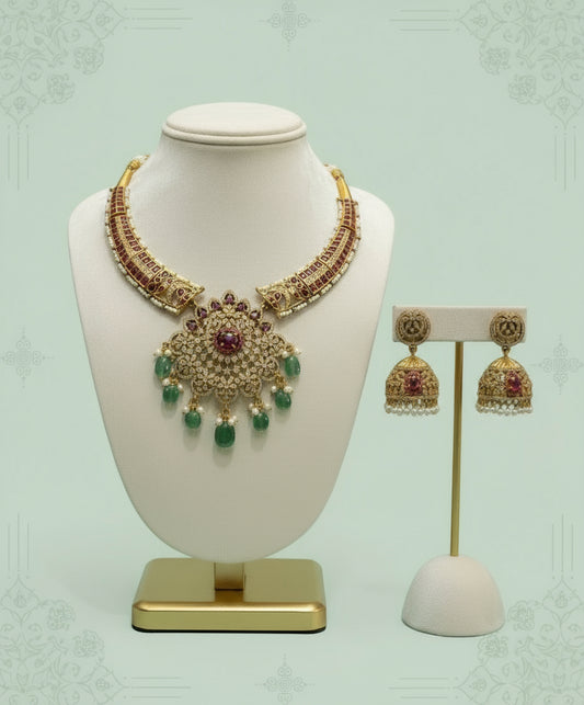 Jewelry set with necklace and earrings on a white mannequin and stand against a light green background