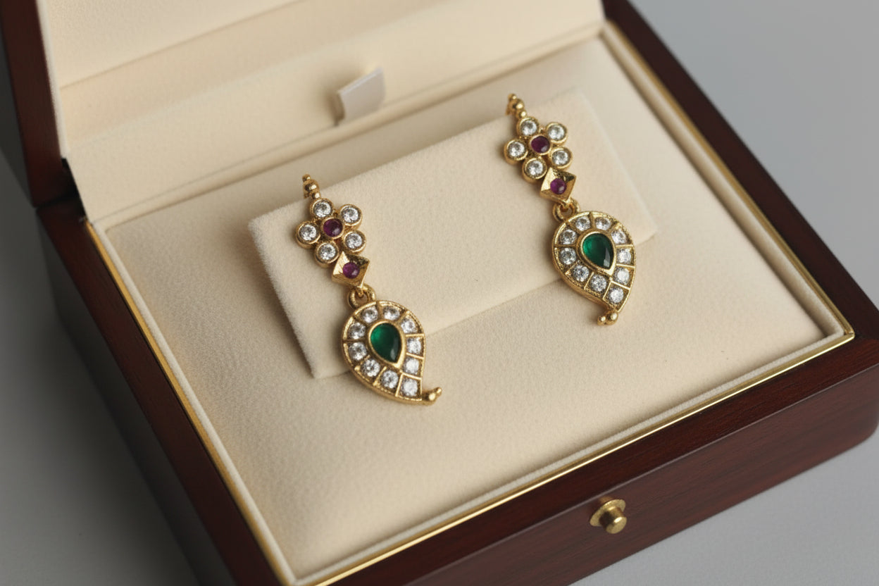 Graceful paisley-patterned necklace set in antique gold finish, adorned with pink and white stones and delicate detailing