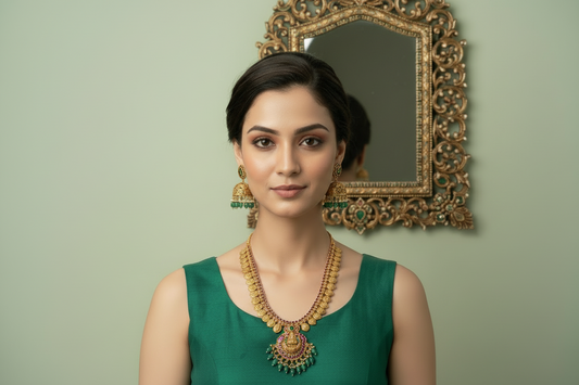 Woman wearing gold necklace and earrings on a light green background