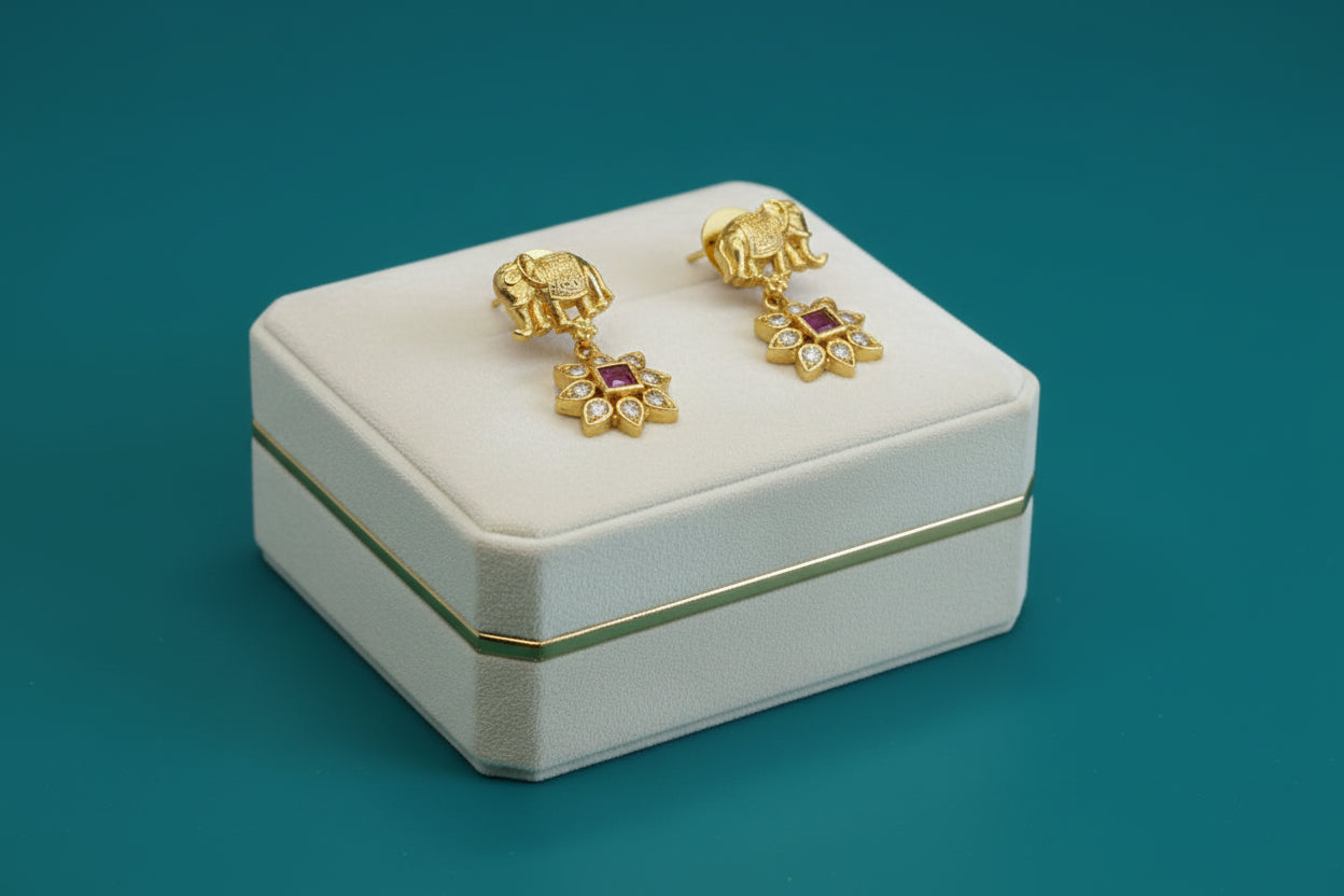 Antique gold necklace featuring elephant motifs alternating with floral CZ and pink/magenta stone clusters, stud earrings