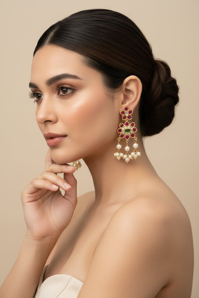 A long traditional necklace with pearl clusters and floral red-green gemstone accents, paired with matching earrings.