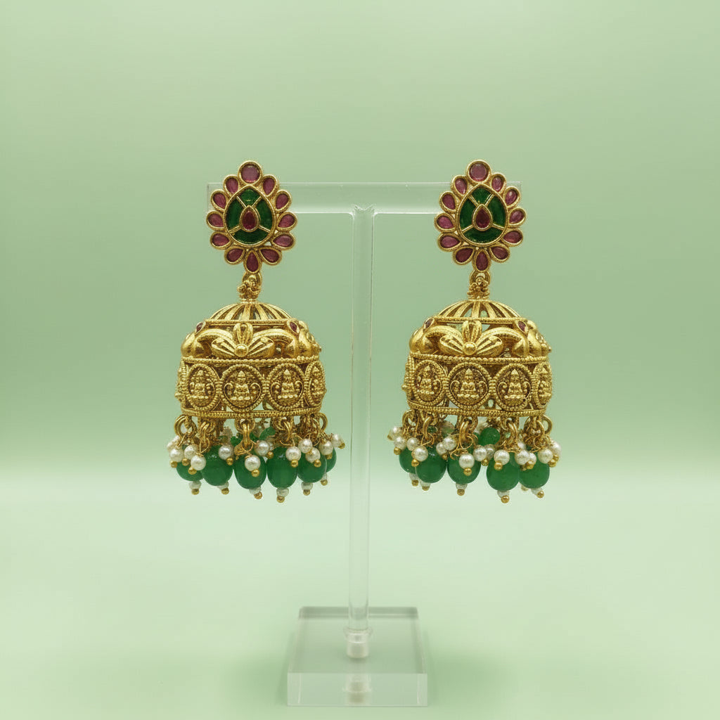 Handcrafted antique gold Kasu Malai necklace with a Lakshmi motif pendant, green bead accents, and jhumka-style earrings