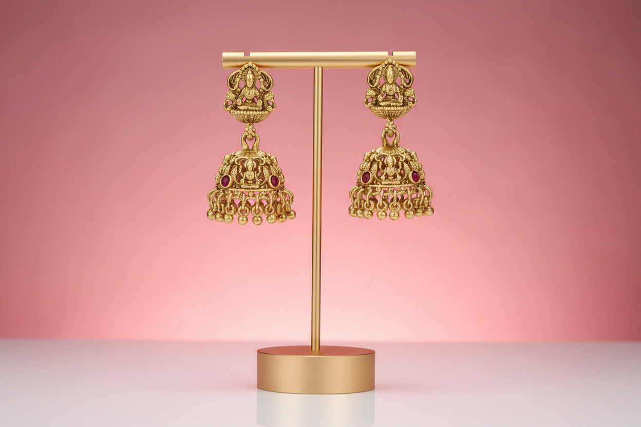 Lakshmi pendant set in antique gold finish, featuring red, green, and pink stones.