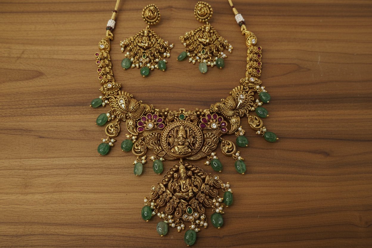 antique necklace with Lakshmi and peacock motifs, pink and white stone and emerald green bead drops, jhumka-style earrings