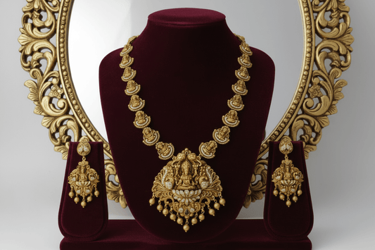 Lakshmi-peacock pendant set in antique gold finish, featuring white stone inlay and gold bead hangings.