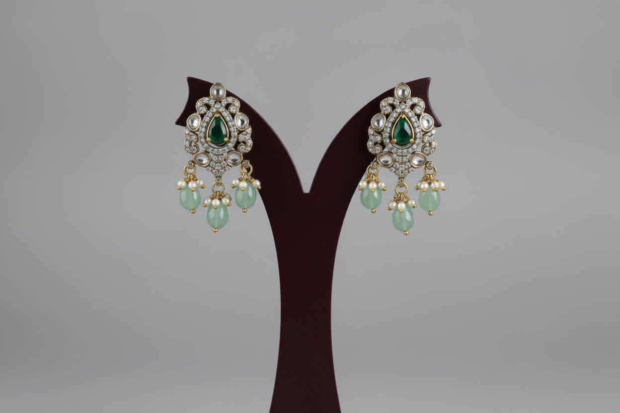 Multi-strand necklace set in gold finish, with a central motif with pink and green stones, white accents, and pearl hangings.