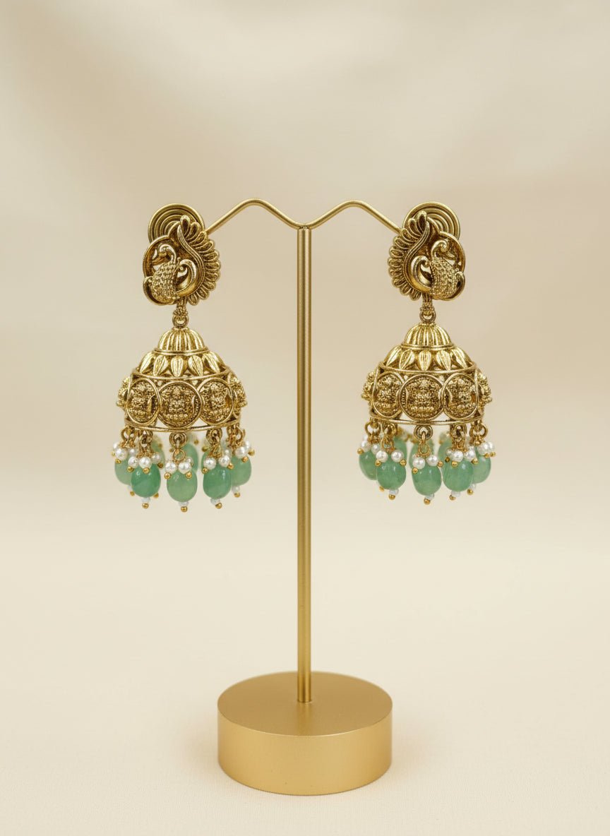 Antique gold long coin necklace with a coin design, paired with matching jhumka earrings featuring emerald green bead drops