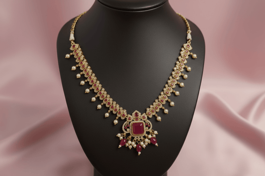 antique gold necklace with ruby-magenta stones, kundan detailing & pearl drops