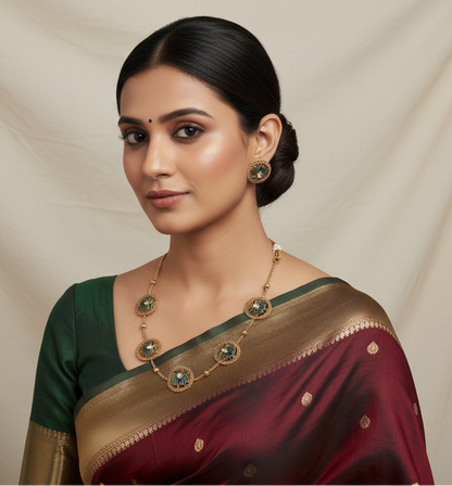Woman wearing a traditional saree with a gold and green blouse against a beige background