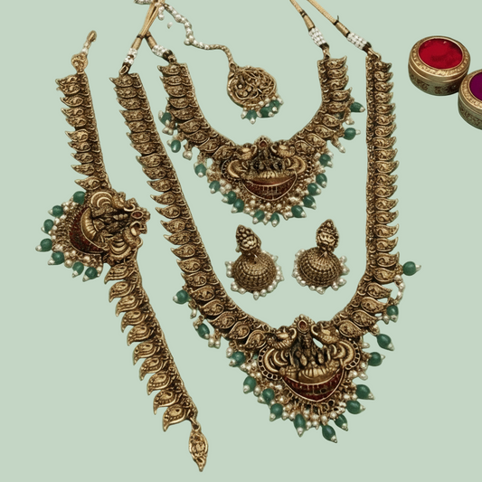 Bridal Set of jewelry including necklaces and earrings on a blue satin background