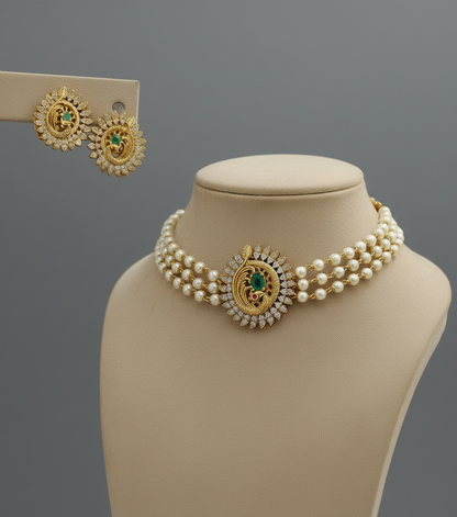 Pearl necklace with gold accents on a mannequin bust, accompanied by matching earrings.