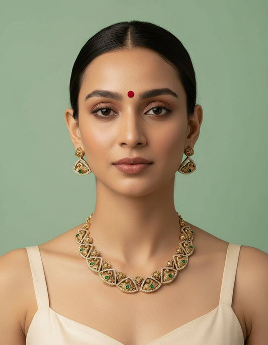 Woman wearing a gold necklace and earrings against a green background