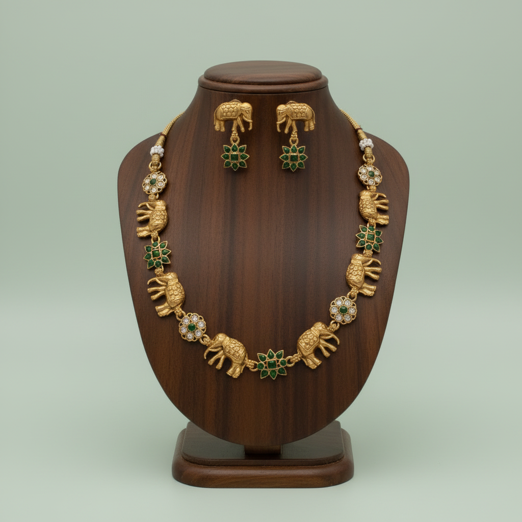 Gold necklace and earrings set on a wooden mannequin against a light green background