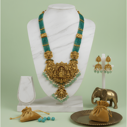 Gold and green south indian bead necklace set on a mannequin with accessories on a light green background