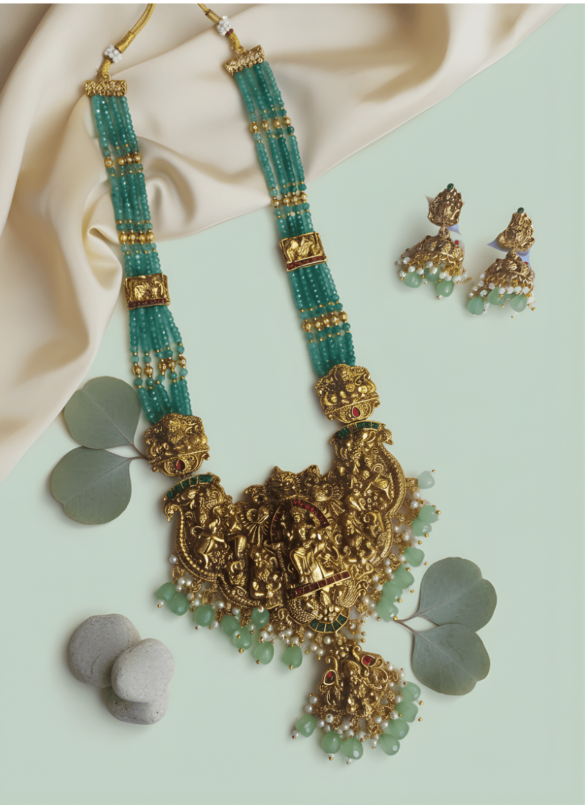 Gold and green bead south indian necklace set with  earrings on a light green background