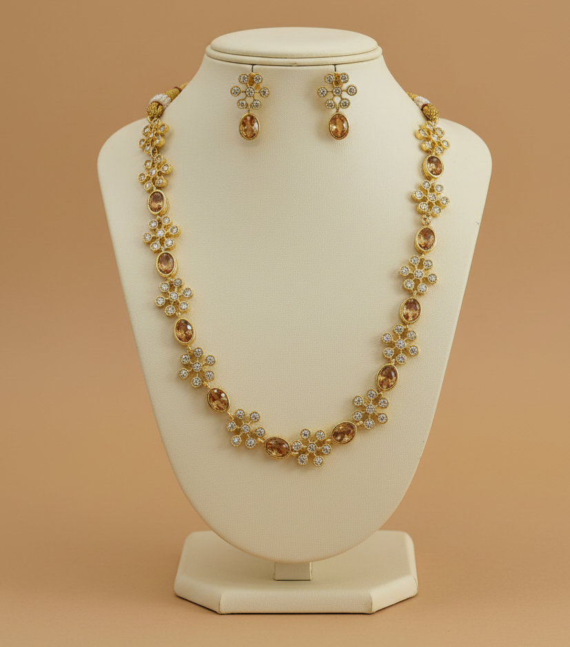 Jewelry set with necklace and earrings on a beige stand against a beige background