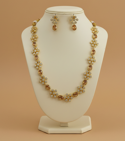 Jewelry set with necklace and earrings on a beige stand against a beige background