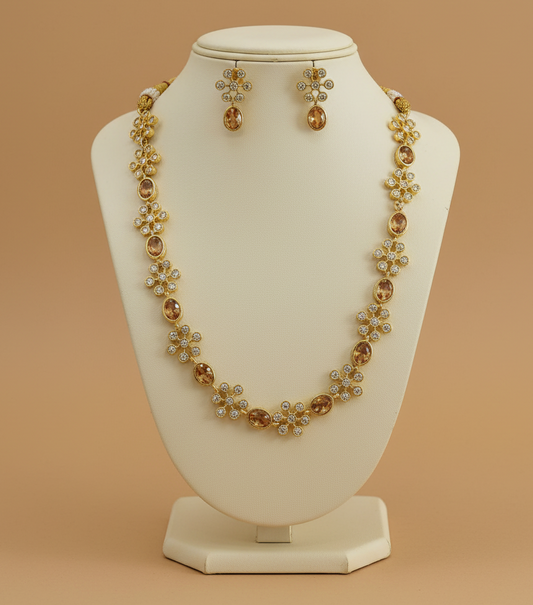 Jewelry set with necklace and earrings on a beige stand against a beige background