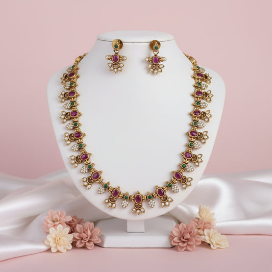 Gold necklace and earrings set on a mannequin 