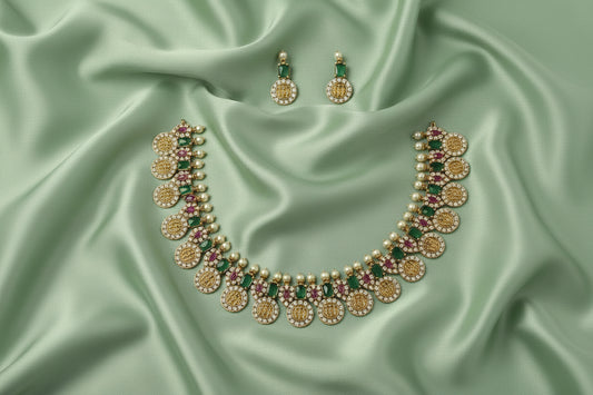 Jewelry set with necklace and earrings on a green satin fabric background
