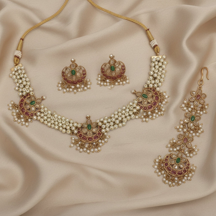 Jewelry set with necklace, earrings, and ring on a beige fabric background