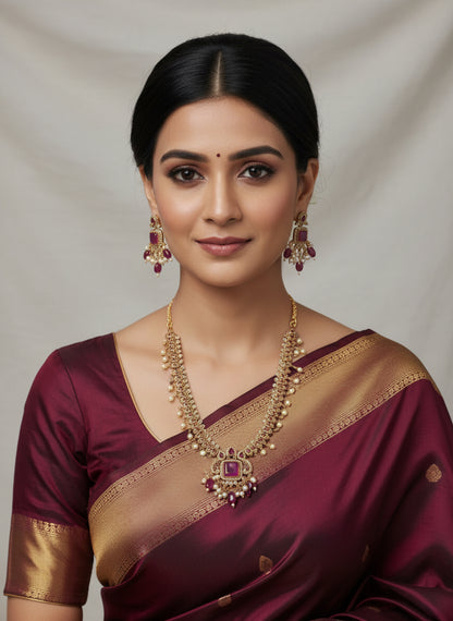 Necklace and earrings set with pink stones on a white background