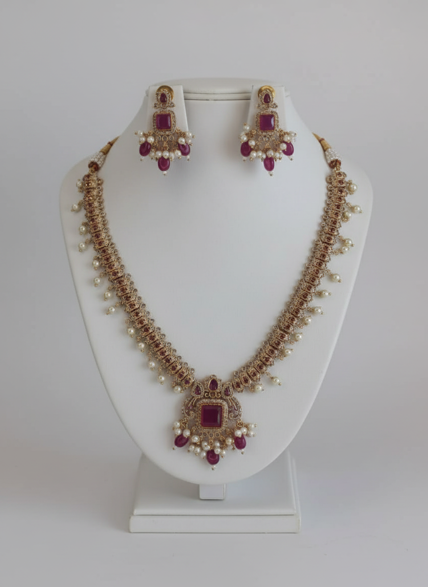 Jewelry set with necklace and earrings on a white stand