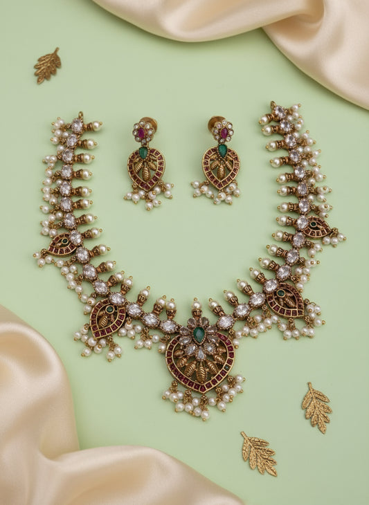 Ornate necklace and earrings set on a beige fabric background 