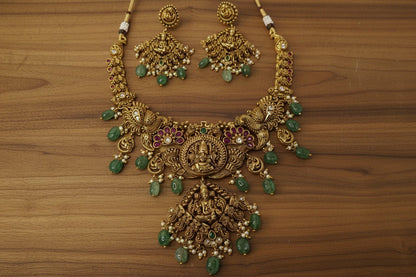 antique necklace with Lakshmi and peacock motifs, pink and white stone and emerald green bead drops, jhumka-style earrings