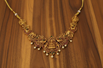 This exquisite handcrafted gold necklace set embodies the grandeur of South Indian temple jewelry.