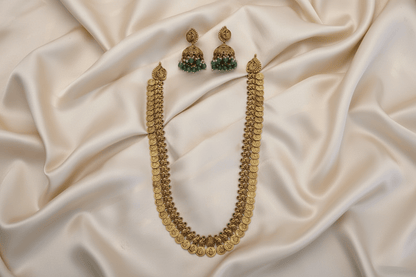 Antique gold long coin necklace with a coin design, paired with matching jhumka earrings featuring emerald green bead drops