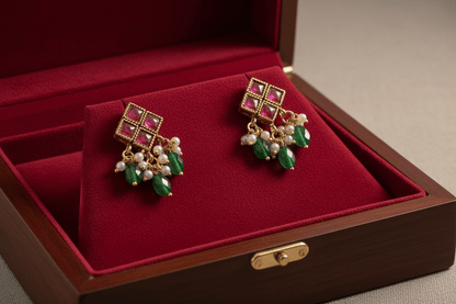 Antique gold necklace with square maroon kemp stone detailing, emerald green bead drops, and matching floral drop earrings