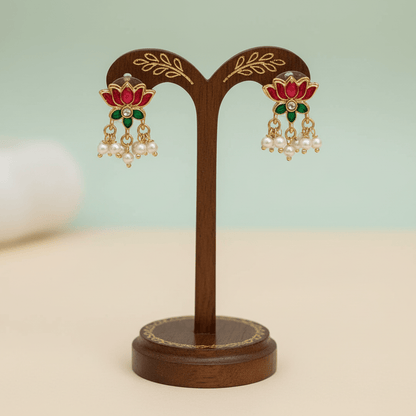 Necklace set featuring gold Lakshmi motifs with pink and green enamel lotus accents, finished with clusters of pearls.