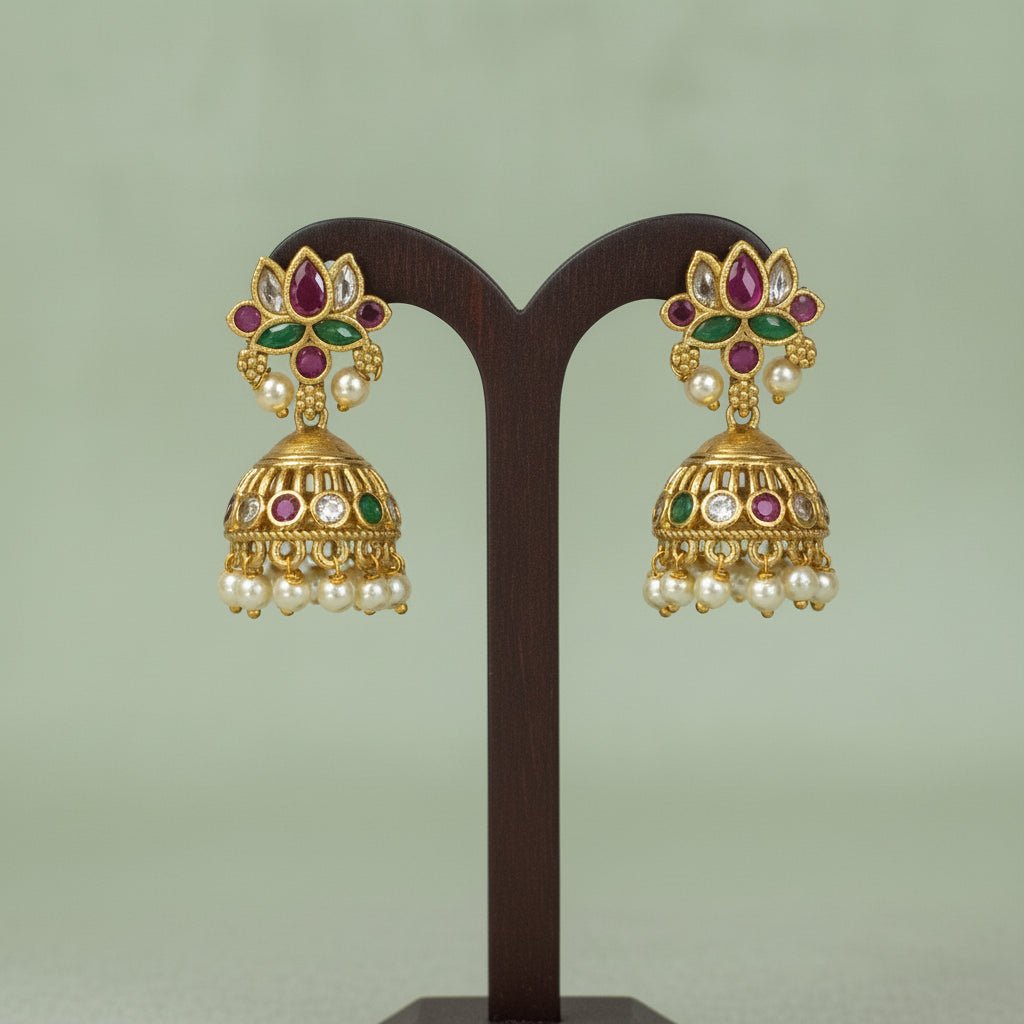 This gold-toned necklace and earring set features pink and green lotus motifs enhanced by delicate pearl hangings.
