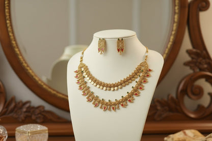 antique gold two-layer necklace with pink mango-shaped stone drops, pearl detailing, and matching drop earrings