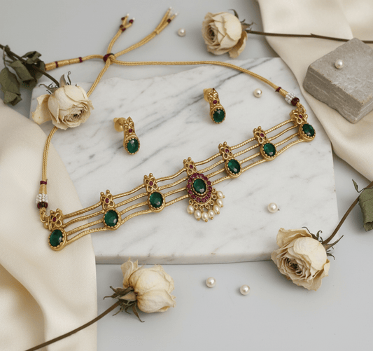 Choker necklace with green stones, pink-green pendant, and pearl drops, paired with matching earrings.