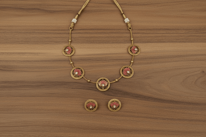 Necklace set with with five medallions, each adorned with a pink lotus motif and a sparkling white stone.