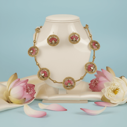 Necklace set with with five medallions, each adorned with a pink lotus motif and a sparkling white stone.