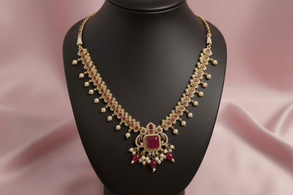 antique gold necklace with ruby-magenta stones, kundan detailing & pearl drops