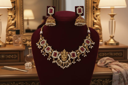 Choker with a central deity figure, framed by intricate motifs, ruby-red stones, shimmering crystals, and pearl danglings.