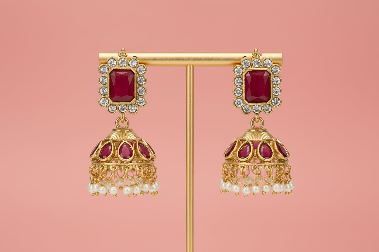 Choker with a central deity figure, framed by intricate motifs, ruby-red stones, shimmering crystals, and pearl danglings.