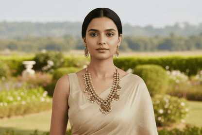 This exquisite gold-hued necklace and earring ensemble features red and green stones, delicate pearl drops.