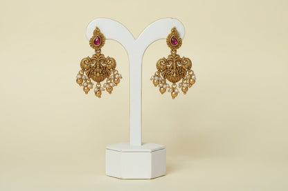 Handcrafted antique gold necklace with multi-strand pearls, a carved deity pendant & kundan accents in premium brass