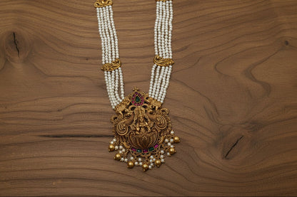 Handcrafted antique gold necklace with multi-strand pearls, a carved deity pendant & kundan accents in premium brass
